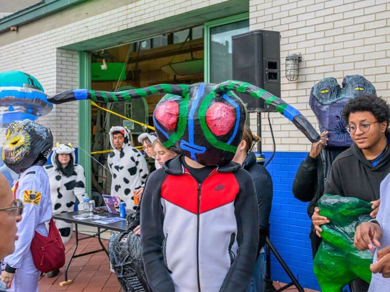 Person wearing paper mâché alien mask