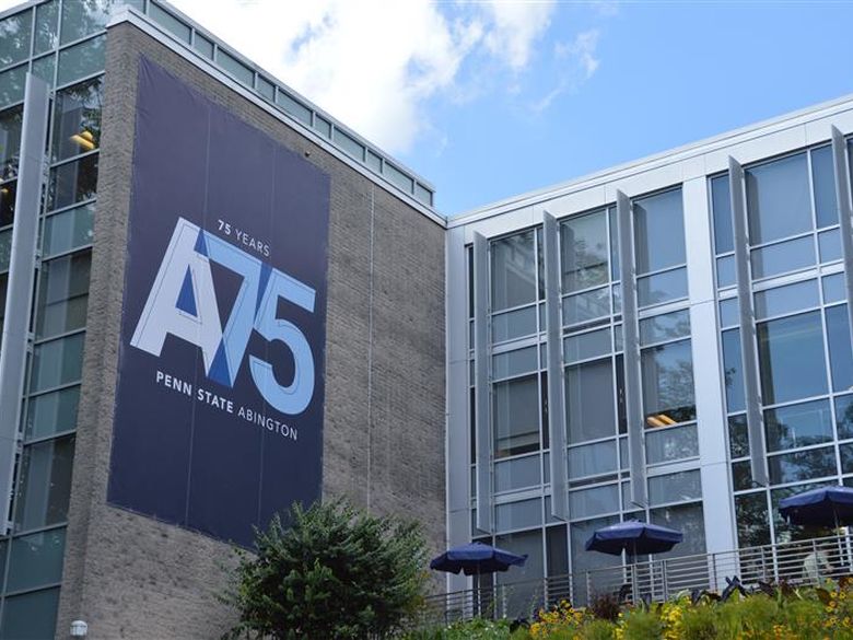 Woodland building with A75 blue banner hanging off the building wall